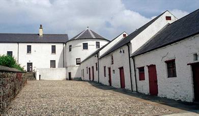 Image of white buildings lining a stone laneway 