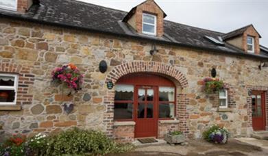 front door of cottage with stone walls 