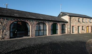 image of the arched windows in a long building 