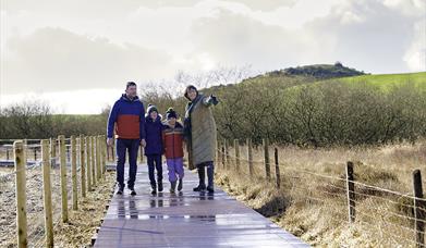 Family walking on boardwalk