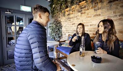 Group of friends at in garden area McAleers Bar