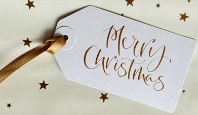 Christmas present tag with "Merry Christmas" written in modern style calligraphy at Seamus Heaney Homeplace