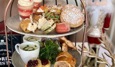 Image of an afternoon tray and a Nutcracker ornament in the background