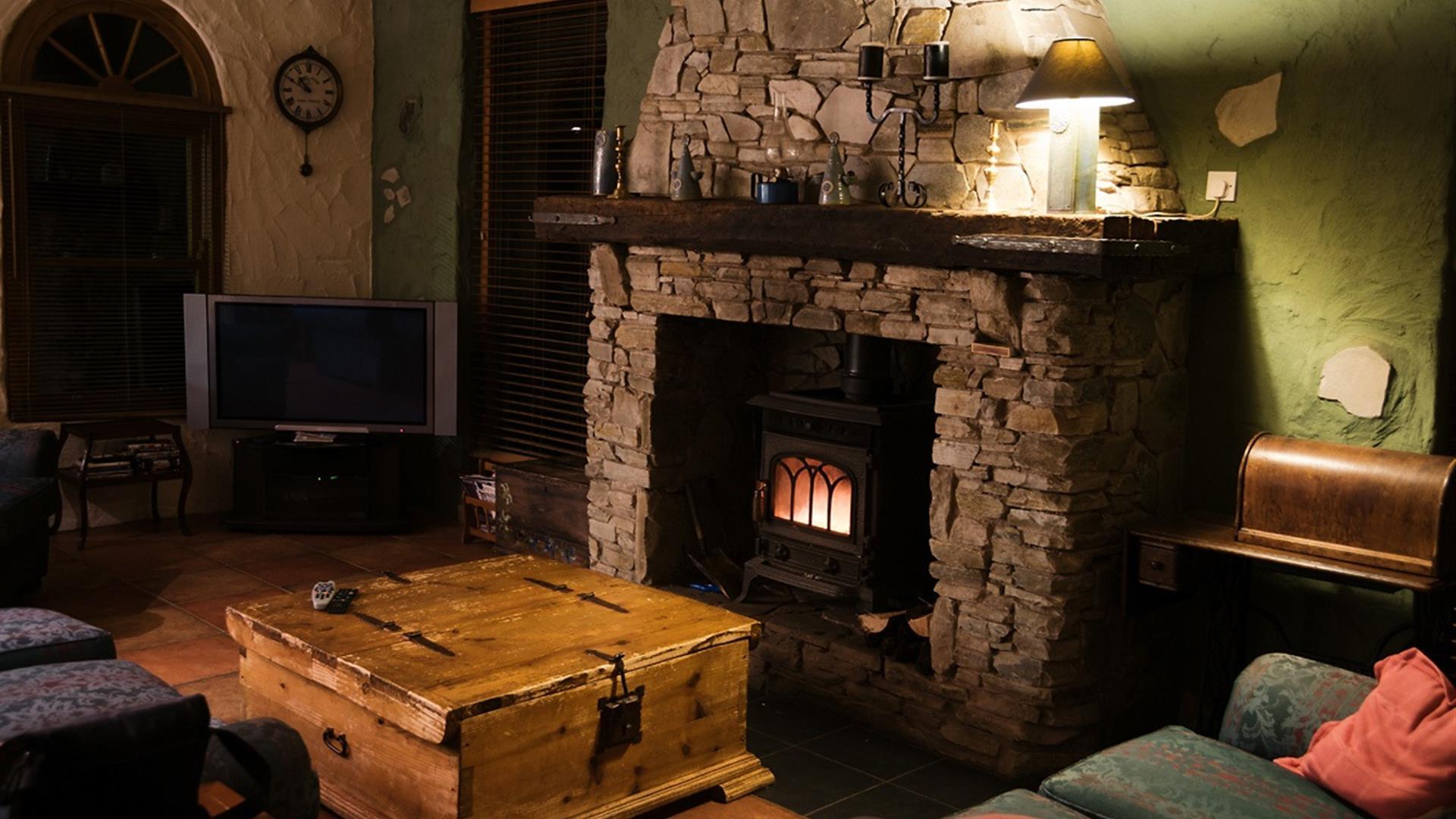 Cosy living room with stone fireplace and burner