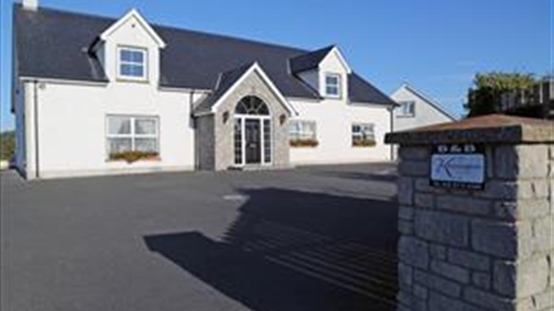 Outside photo of Kensington Lodge, white windows and black door