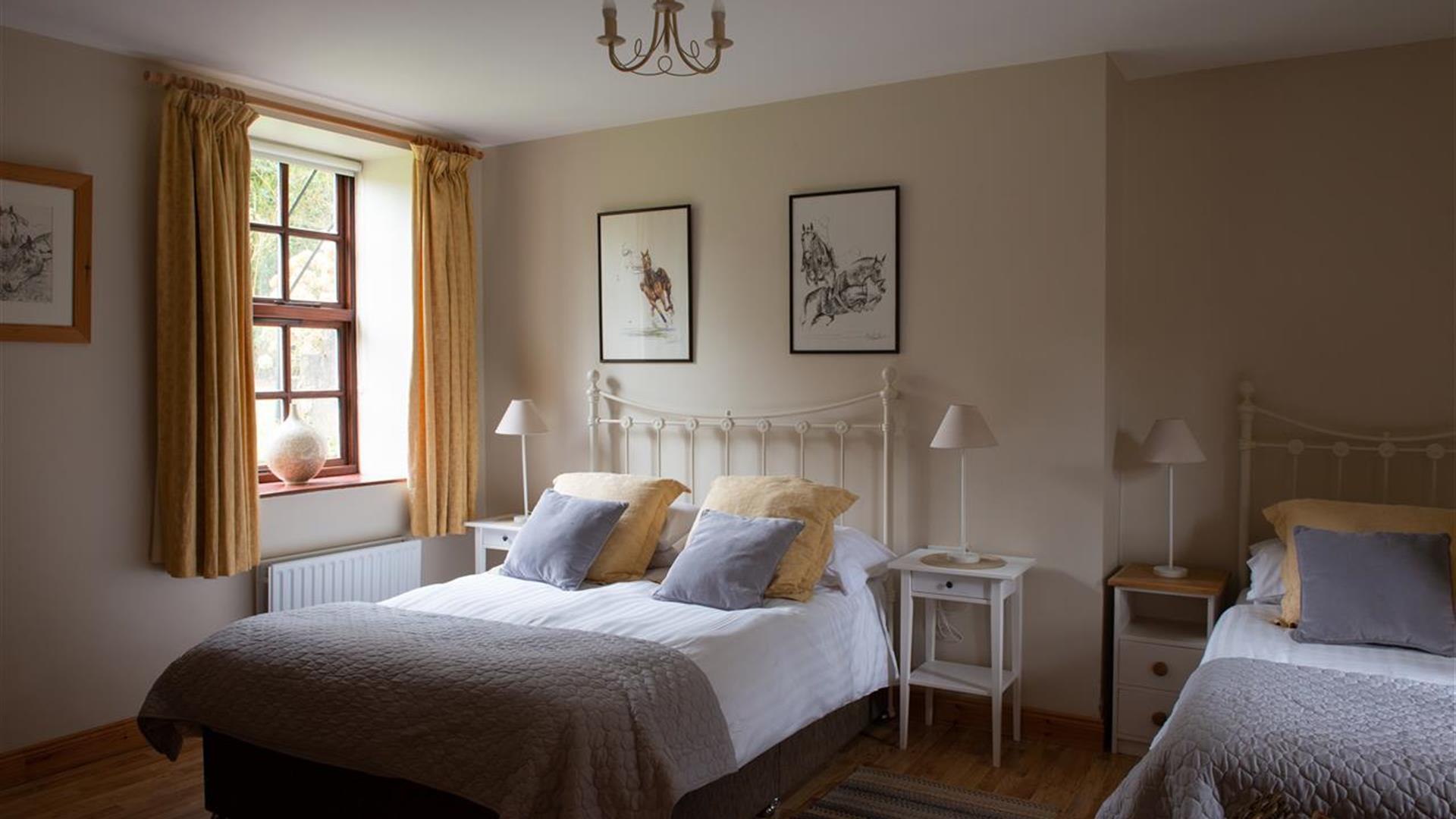 Spacious Triple bedroom with grey and yellow colour scheme