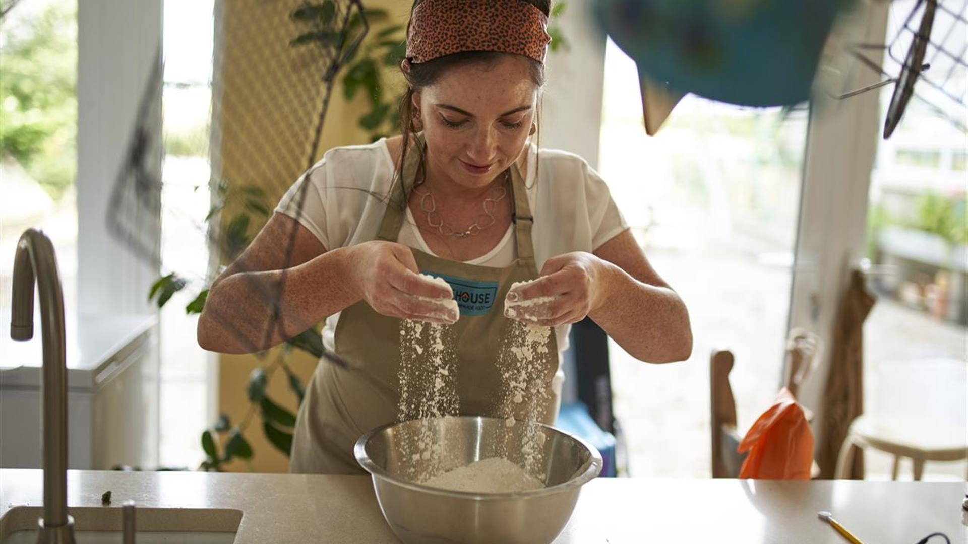 Image of one of the local producers Bronagh Duffin from Bakehouse NI sieving flour into a bowl