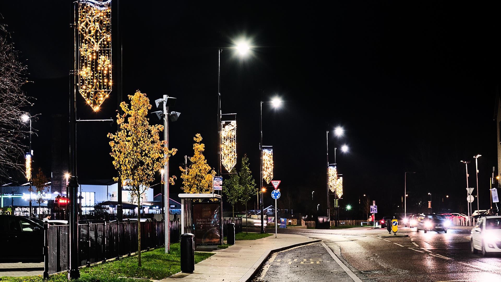 The image is taken at night and shows the Christmas Lights illuminating Lineside in Coalisland