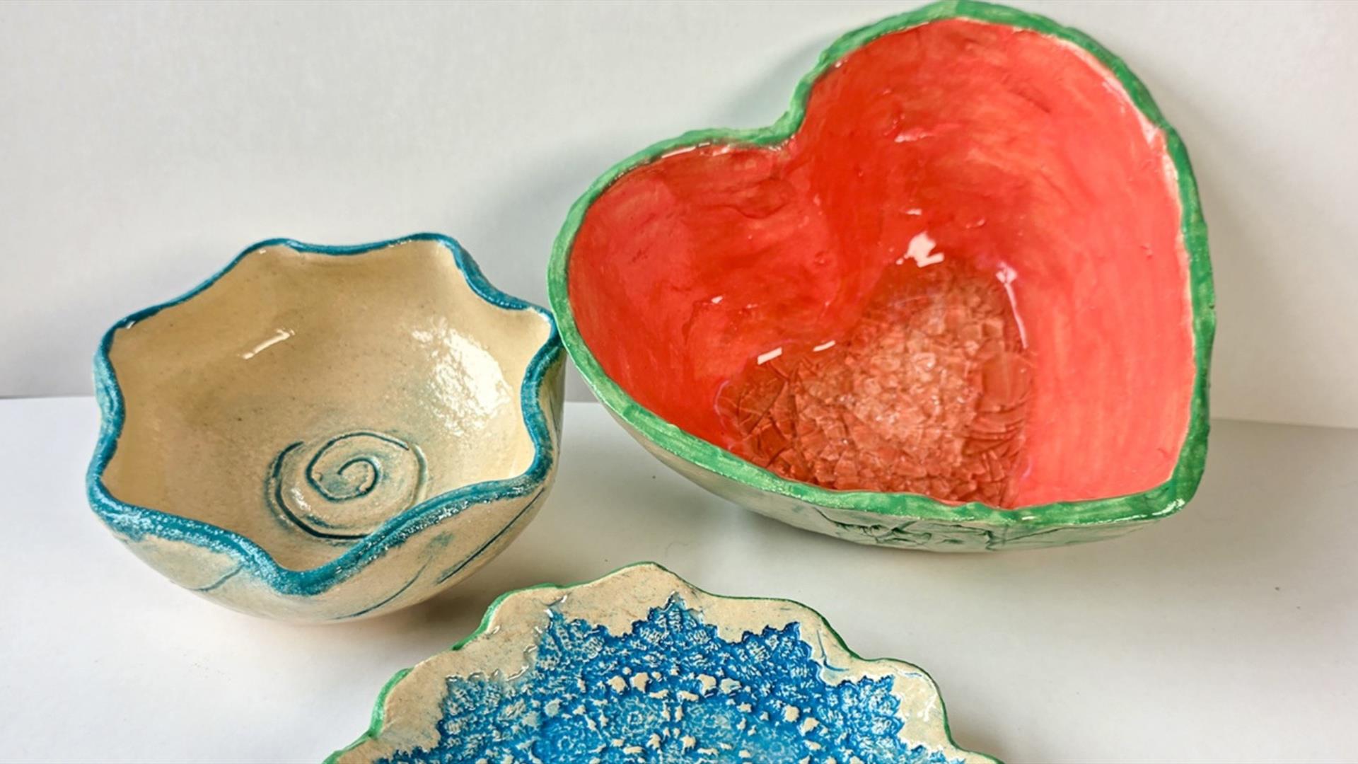 Photo showing 3 vessels of pottery shaped like a star, heart and flower.