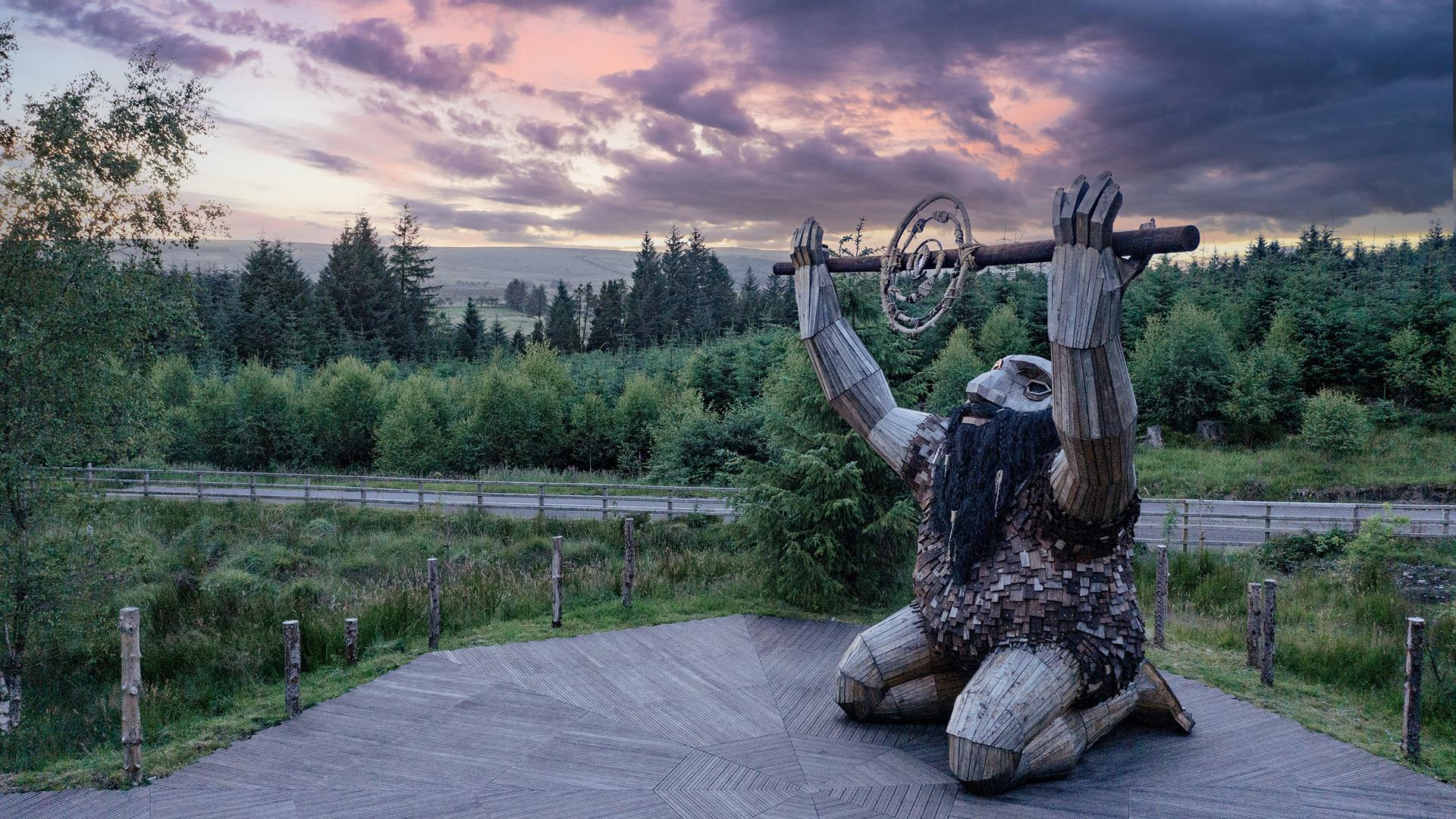 Ceoldán, the Stargazer, kneeling on a timber boardwalk