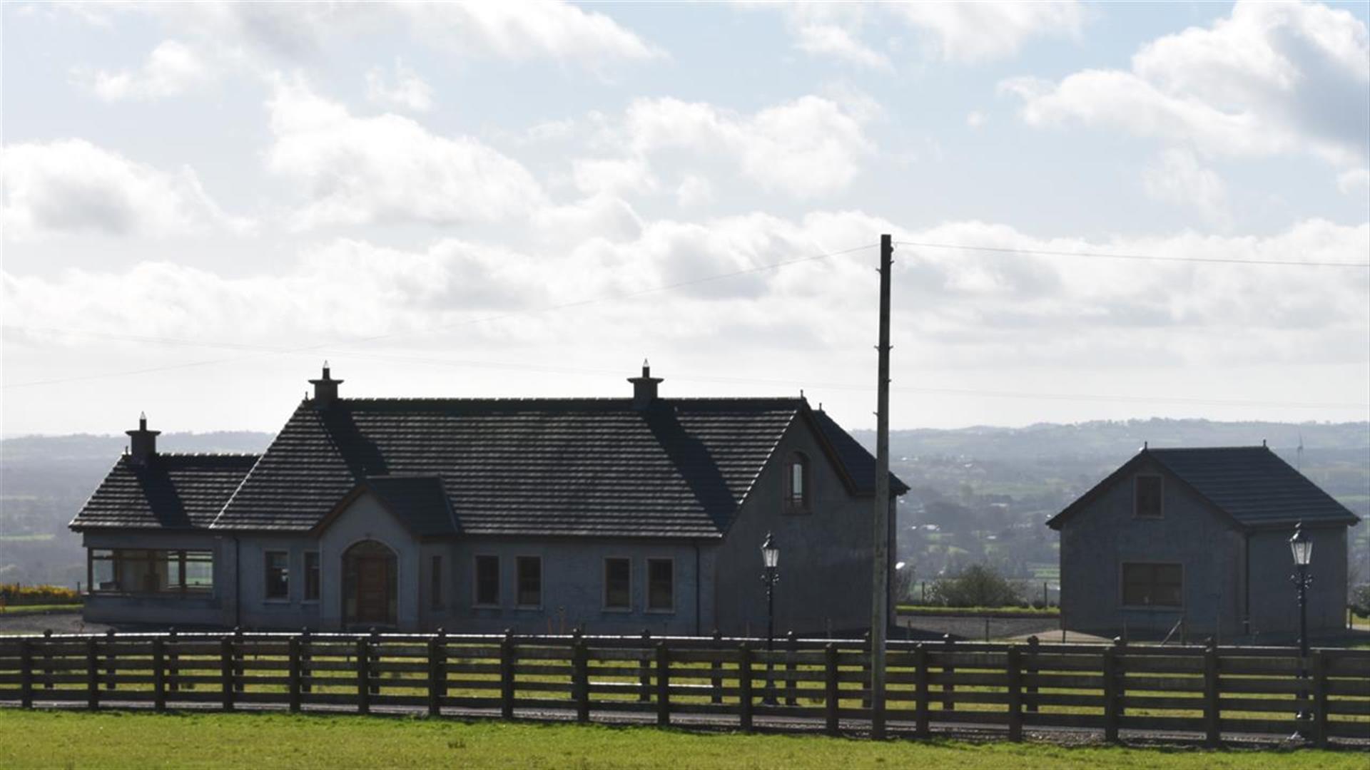 Image of a Bungalow and garage from across a field