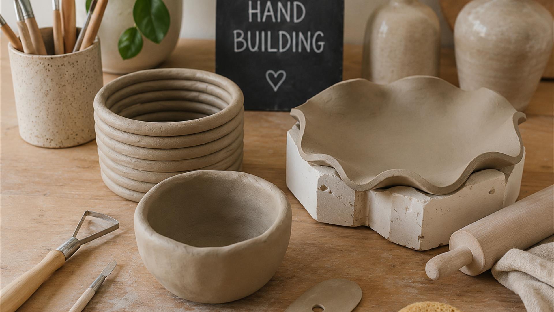 Image of hand built pottery of various shapes and sizes, and clay tools used to create it.