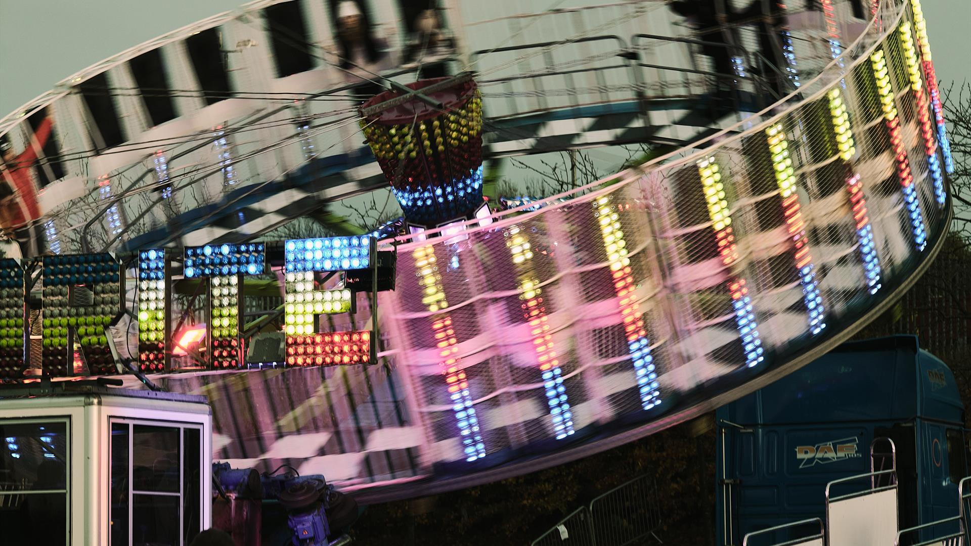 Circular amusement covered in bright lights