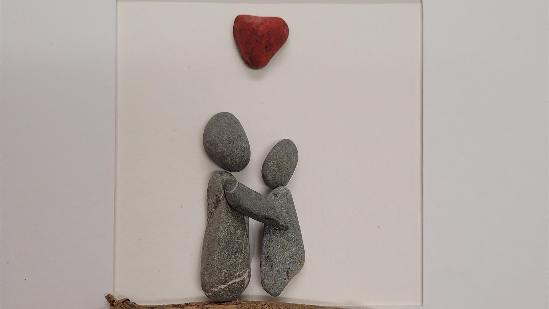 Pebbles Stuck to a page depicting a couple