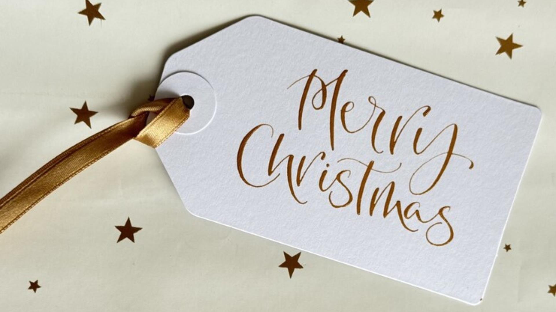 Christmas present tag with "Merry Christmas" written in modern style calligraphy at Seamus Heaney Homeplace