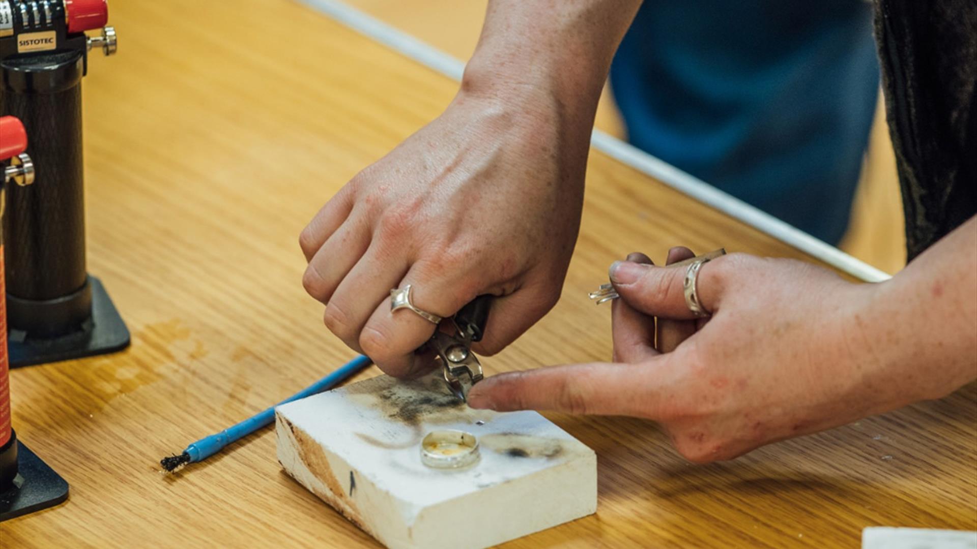 Person handcrafting a claddagh ring at Ranfurly House