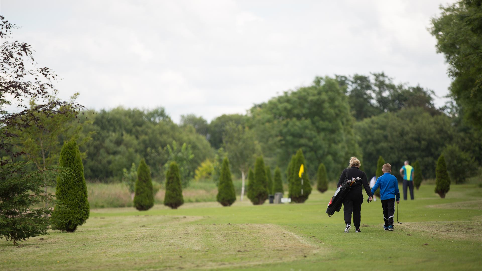 Two people walking on the golf course