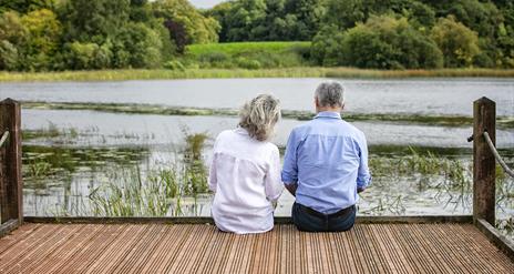 A couple sitting at the lake on Belssingbourne Estate.