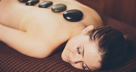 Lady enjoying a hot stone massage