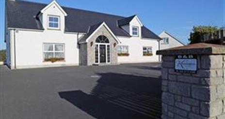 Outside photo of Kensington Lodge, white windows and black door