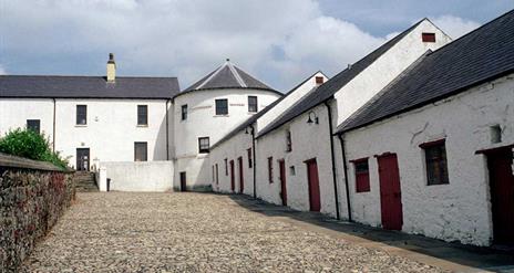 Image of white buildings lining a stone laneway