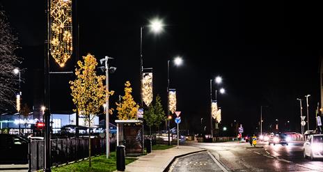 The image is taken at night and shows the Christmas Lights illuminating Lineside in Coalisland