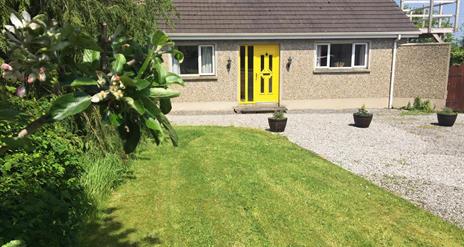 Outside image of house with yellow door