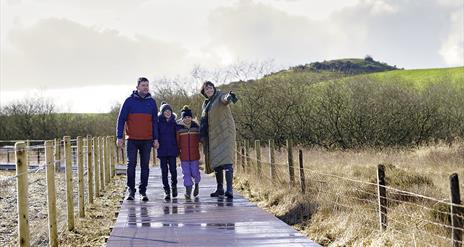 Family walking on boardwalk