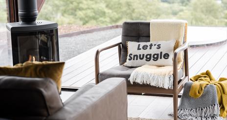 Armchair, stove and blankets in living area