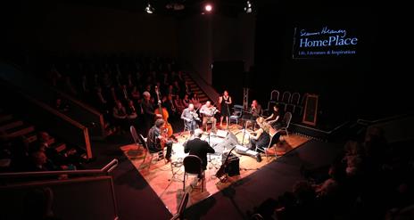 A group of musicians in the Helicon performance space at Seamus Heaney HomePlace