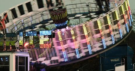 Circular amusement covered in bright lights