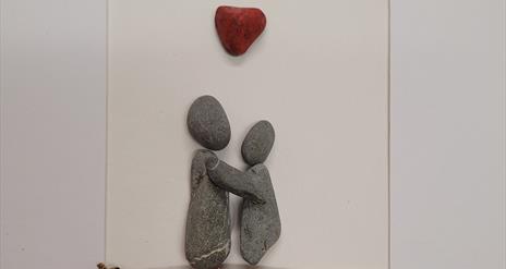 Pebbles Stuck to a page depicting a couple