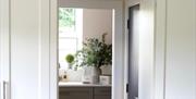 View through fitted kitchen units into utility area.