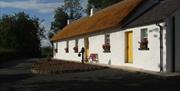 Outside image of cottage with yellow doors