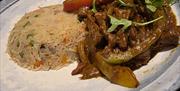 Kadi Beef Curry with Cumin Rice - Fillet Steak strips, stir fried and blended with Kadi sauce and Rice for a fusion of local and Indian flavours 
