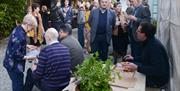 Large gathering of people eating and conversing