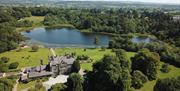 Aerial view of Blessingbourne beside a scenic lake.