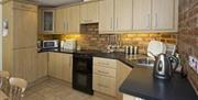 kitchen area with wooden cabinets