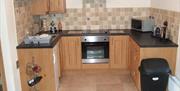 kitchen area with wooden cabinets