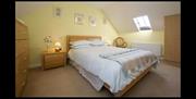 double room with bedside lockers and chest of drawers