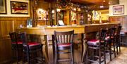 Bar at The Ryandale with surrounding bar stools