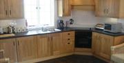 Kitchen area with wooden cabinets