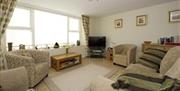 living area with several chairs, TV and coffee table