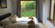 double bedroom with patio doors to balcony