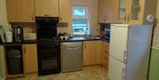 Kitchen area with wooden cabinets