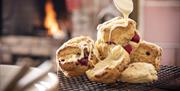 Image of white chocolate being drizzled over raspberry scones