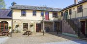 Courtyard apartments with outdoor seating and external staircase.