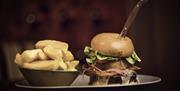 a plate of gourmet burger and chips