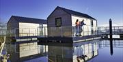 A family at the back of  the house boat glamping pods at Ballyronan Marina