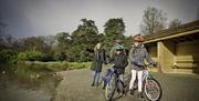 Family with bikes at a pond